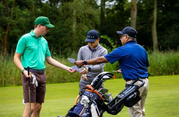 Golfers looking at scorecard